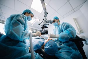 dentists performing a dental procedure on a patient.